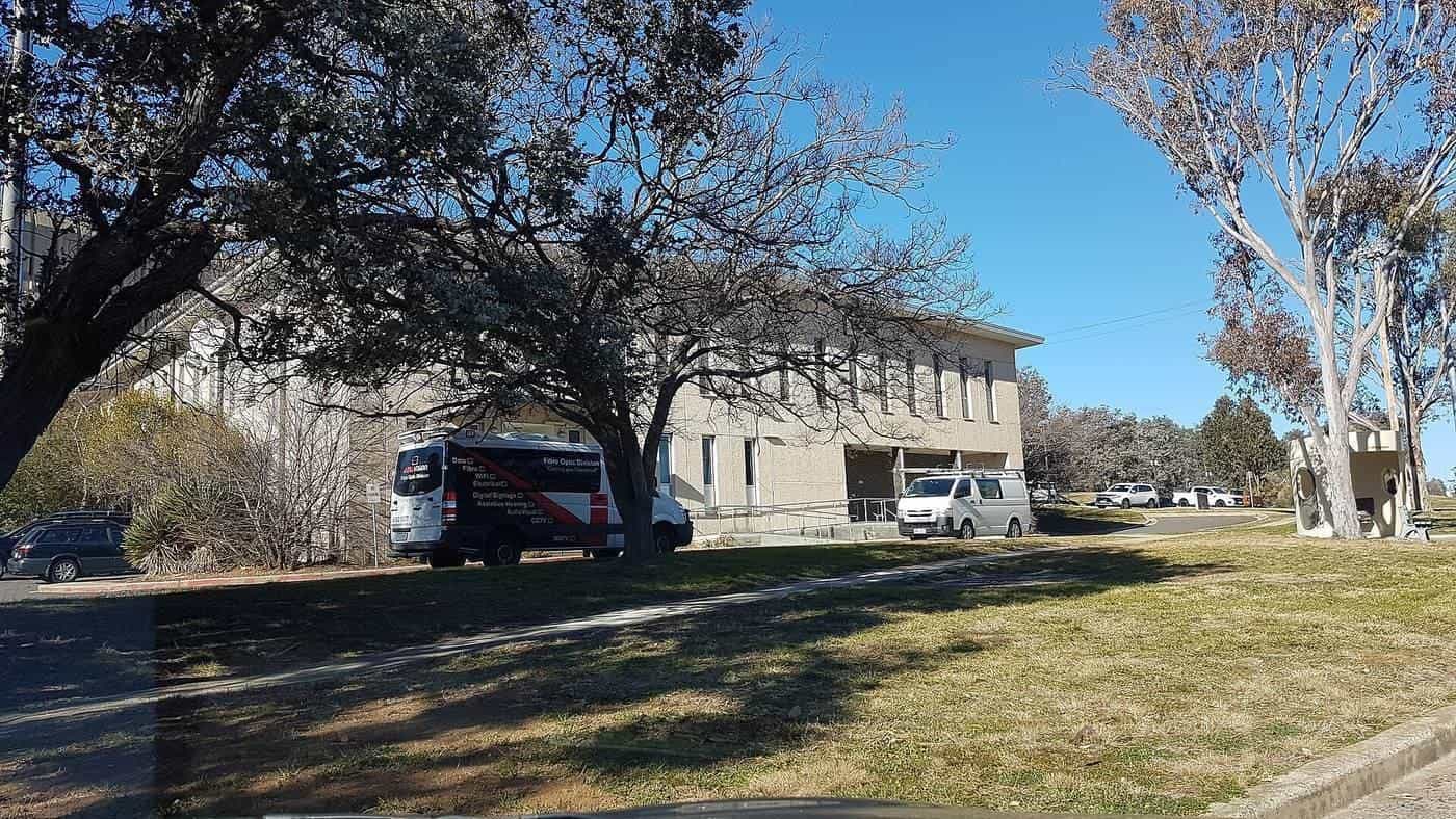 Telephone exchange building among gum trees on a lawn