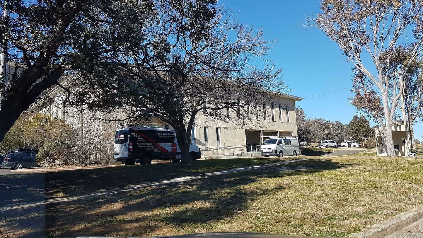 Telephone exchange building among gum trees on a lawn